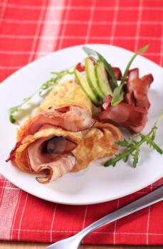 Egg omelet with bacon and grilled sausages