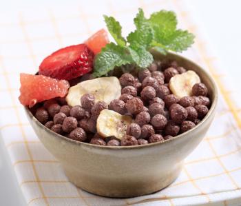 Cocoa-flavored puffed grain breakfast cereal