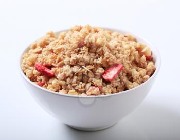 Bowl of crunchy granola with dried strawberries