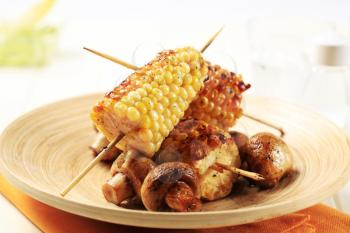Grilled sweet corn cobs and button mushrooms