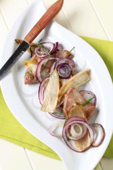 Pan fried pork tenderloin with onion and endive leaves