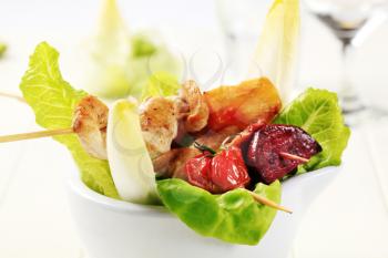 Chicken kebabs on leaves of fresh lettuce