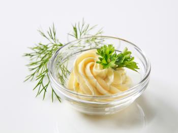Swirl of fresh butter in a glass dish