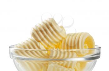 Curls of fresh butter in a glass bowl