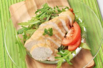 Sliced chicken breast fillet and vegetable garnish