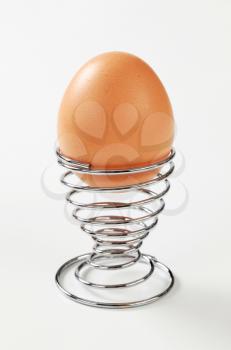 Egg in modern spiral metal egg cup