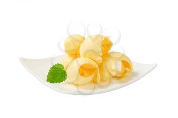 Curls of fresh butter on a plate