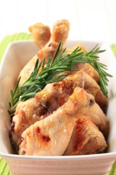 Chicken drumsticks with rosemary in a casserole dish
