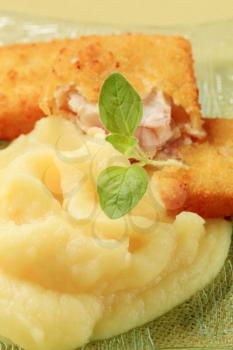 Fried breaded fish fillets served with mashed potato