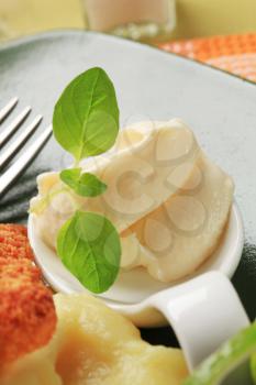 Creamy horseradish sauce on a porcelain spoon