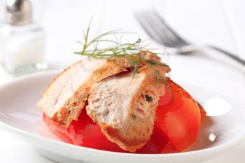 Slices of marinated chicken breast and tomato