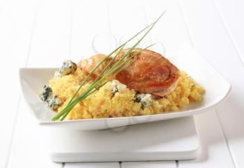Roast chicken breast served with couscous and blue cheese