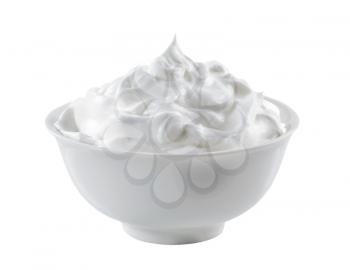 Bowl of whipped cream isolated on white