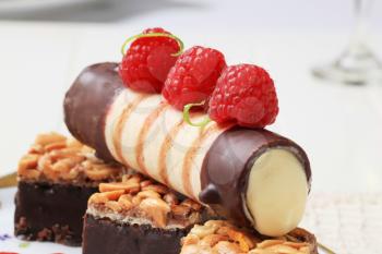 Chocolate dipped wafer cookies and custard filled pastry tube 