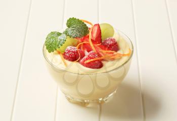 Bowl of creamy pudding topped with fresh fruit 