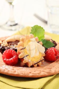 Chocolate and vanilla cream tartlets garnished with raspberries