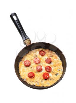 Egg omelet and cherry tomatoes in a frying pan