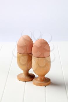 Boiled eggs in wooden eggcups 