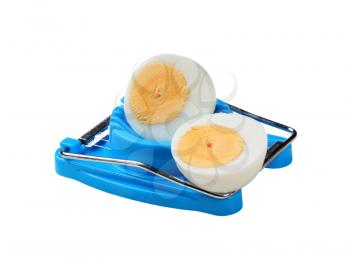 Halved boiled egg and an egg cutter