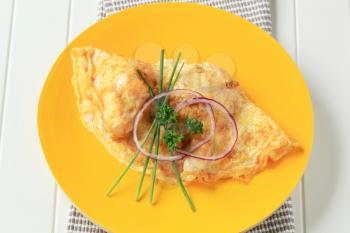 Egg omelet on yellow plate