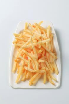 Portion of French fries on plastic plate