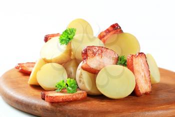 New potatoes and bacon on a cutting board