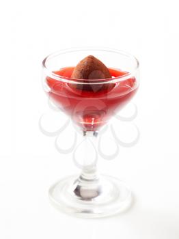 Chocolate truffle in a glass of fruit coulis