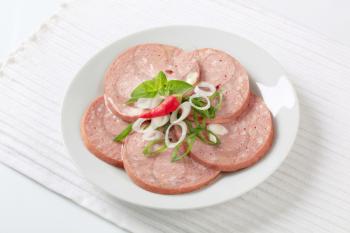 Sliced Mortadella-like sausage sprinkled with spring onion