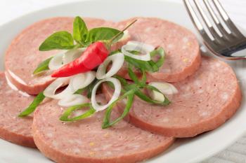 Sliced Mortadella-like sausage sprinkled with spring onion