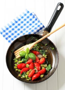 Sauteeing vegetables in a fry pan