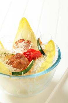 Meatballs with cellophane noodles, courgette and endive 