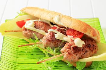 French baguette with minced meat kebabs