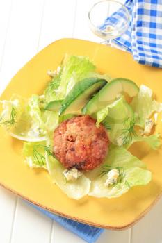 Meat patty with lettuce, avocado and blue cheese