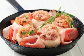 Mushrooms stuffed with ground meat and slices of ham