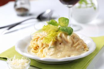 Spaghetti with creamy sauce and grated Parmesan