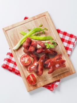 Grilled sausages on a cutting board - studio