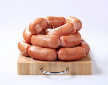 Pile of sausages on a cutting board