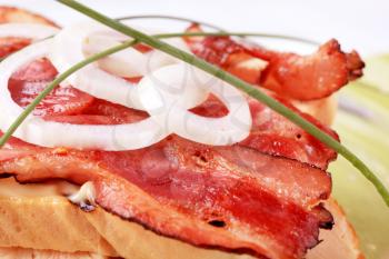 Rashers of roasted bacon on bread - detail