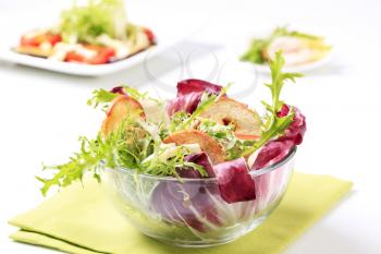 Bowl of green salad with crostini and cheese