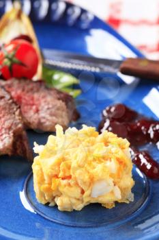 Slices of roast beef with  scrambled eggs and plum sauce