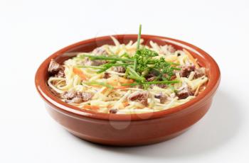 Bowl of beef soup with homemade noodles