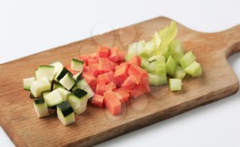 Diced courgette, carrot and celery on a cutting board