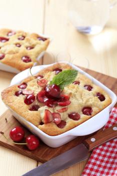 Cherry sponge cakes in square porcelain dishes