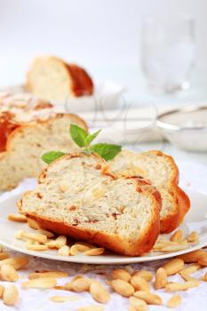 Slices of sweet braided bread and blanched almonds