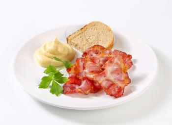 Crispy bacon slices with bread and mustard sauce