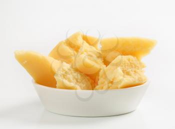 Pieces of Parmesan cheese in a bowl