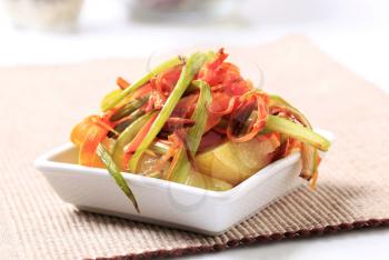 New potatoes and strips of sauteed vegetables 