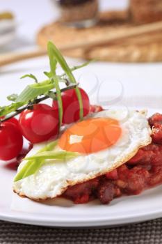 Vegetarian dish of red bean and tomato salad and fried egg