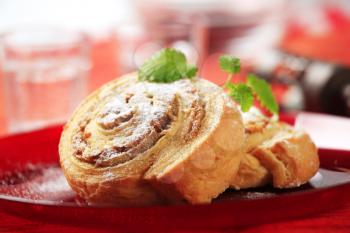 Sweet pastry rolls with nut filling dusted with icing sugar