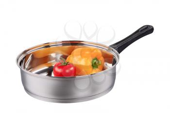 Fresh tomato and yellow pepper in a saucepan